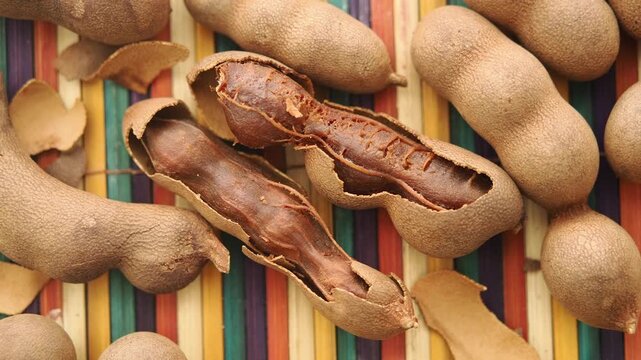Tamarind fruit on a colorful mat