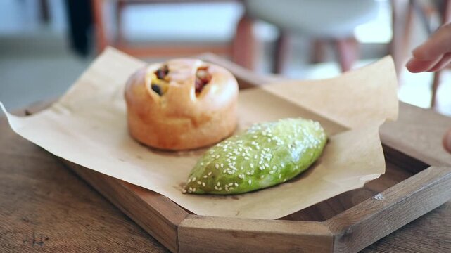 Enjoying two types of baked goods on a wooden tray