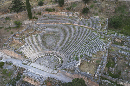 Aerial view of the ancient theatre of Delphi with its well-preserved stone tiers and semicircular orchestra nestled on the hillside Delphi, Greece.