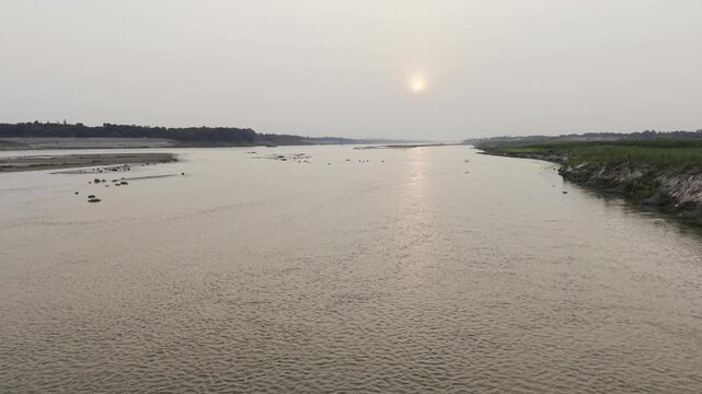 Scenic sunset landscape captured from a drone above the Garai River, a distributary of the Padma River.
