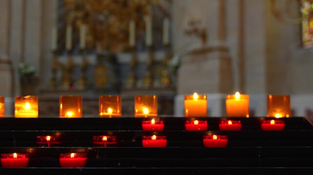 Rows of glowing votive candles inside the Royal Chapel at Versailles
