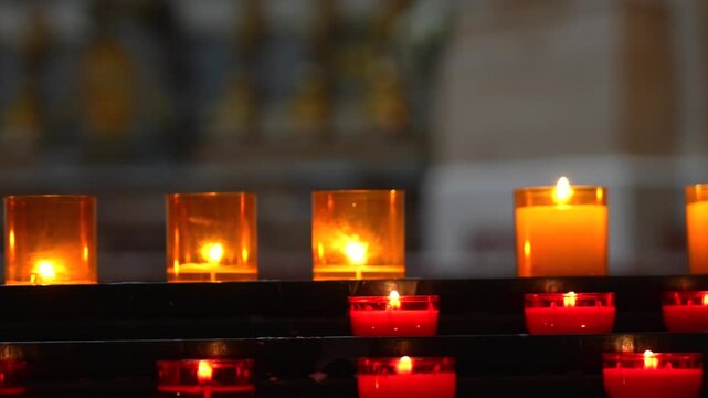 Close up of glowing votive candles during Christian prayer