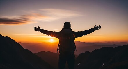 Fototapeta premium Silhouette of a person with arms outstretched on a mountain peak at sunset, celebrating freedom and achievement.