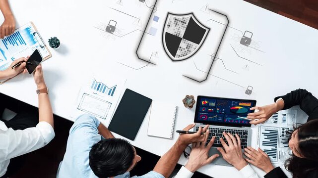 Collaborative Business Meeting Focusing on Data Security and Analytics with Digital Shield Symbol Representing Protection on the Desktop. Raster.