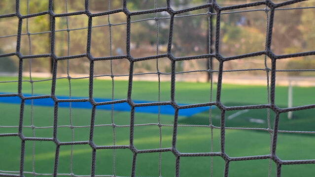 Raindrops on Soccer Goal Net with Blurred Field Background