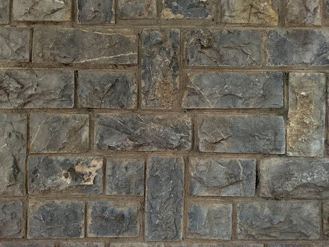 Close-up Textured Old Stone Wall with Weathered Bricks and Mortar in Natural Light