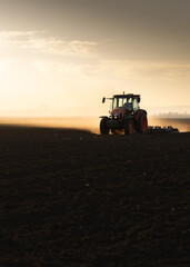 Fototapeta premium Tractor preparing the land for a new crop planting