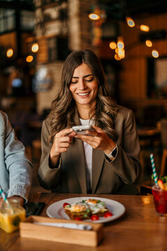 Woman taking food picture for social media sharing