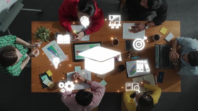 A diverse team engages in a collaborative educational project, surrounded by dynamic graphics and charts, highlighting creativity and innovation in a modern workspace. Raster