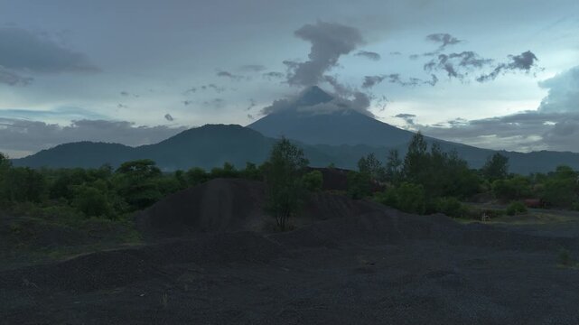 Aerial view of Mayon Volcano rising above gravel quarry and tropical landscape in Albay Philippines. Ideal for environmental and documentary projects.