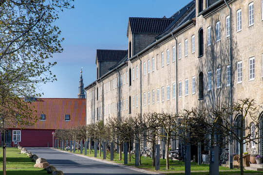 Residential area in historic buildings in the dock area of Copenhagen, Denmark with in background the spire of the Church of Our Saviour (Vor Frelsers Kirke)