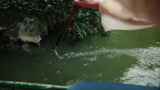 Boat ride on trang an waterways in Ninh Binh, Vietnam scenic landscape.