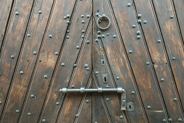 Old Wooden Door With Iron Latch and Keyhole Detail © Paolo Gallo
