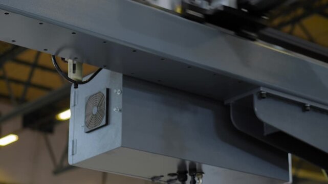 Automatic pick and place robotic arm manipulator with suction cups moves white polypropylene yogurt containers: plastic injection molding machine at plant, exhibition, factory - close up view