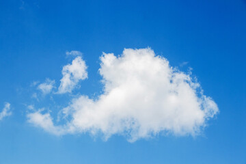Fototapeta premium Single fluffy white cumulus cloud in a deep blue sky good weather and minimalism concept
