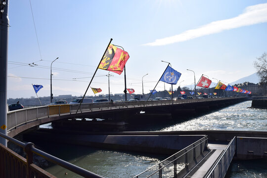 Mont blanc bridge decorated with flags, geneva cityscape