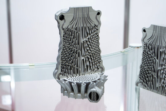 Object printed on 3D printer. Heat exchanger with conformal cooling channels. Model printed on 3D printer from metal powder. Aluminum alloy. Selective Laser Melting. SLM. Additive manufacturing.