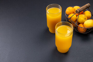 Apricot juice in glasses with fresh fruits © Victoria Kondysenko
