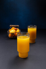 Pouring fresh homemade apricot juice in glass © Victoria Kondysenko