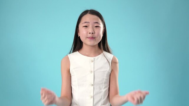 Expressive asian girl showing various hand gestures and emotions in studio