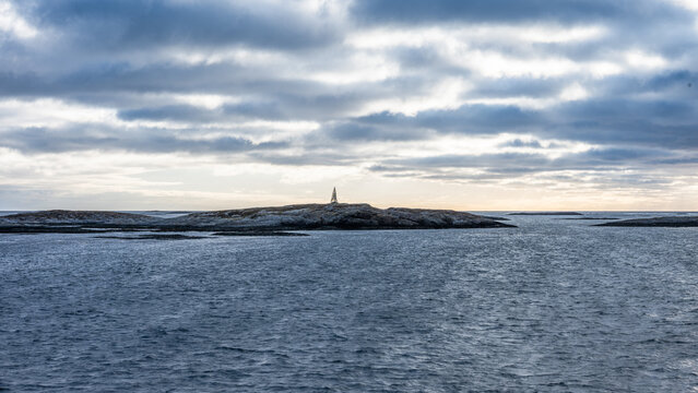 Traditional Scandinavian navigational markers near rocky islands in Trondelag county in Norway