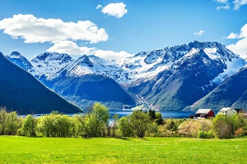 Fototapeta premium Landscape around the Hjorundfjord in Norway with mountains, and green fields on a sunny day