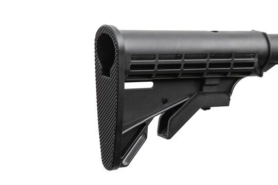Close-up of a black adjustable plastic buttstock of an AR-15 rifle on white back