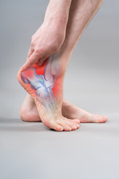 Achilles tendon pain or heel spur. Man holding his injured foot with red graphic of inflammation. Orthopedics and sports injury concept
