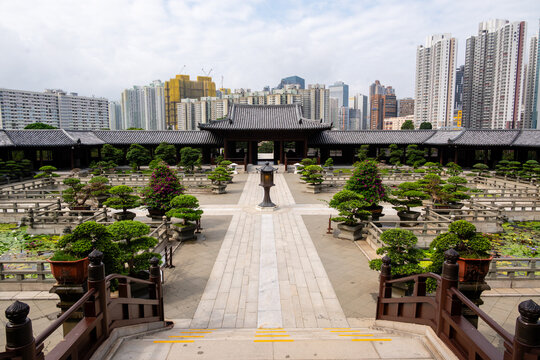 Elevated symmetrical view of Chi Lin Nunnery courtyard and entrance gate contrasted with Hong Kong skyscrapers