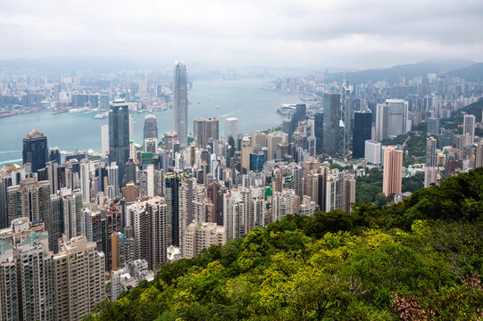 High angle panoramic view of Hong Kong Island skyscraper skyline and Victoria Harbour from Lugard Road Lookout on Victoria Peak