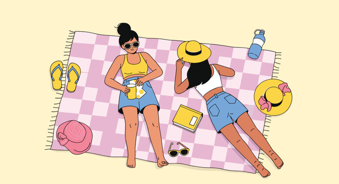 Two women relax and sunbathe on a checkered picnic blanket at the beach, surrounded by summer accessories, symbolizing leisure and vacation.