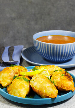 Golden Fried Empanadas With ALGERIA harira Soup, Glass of Milk and Lemon Garnish on Plate