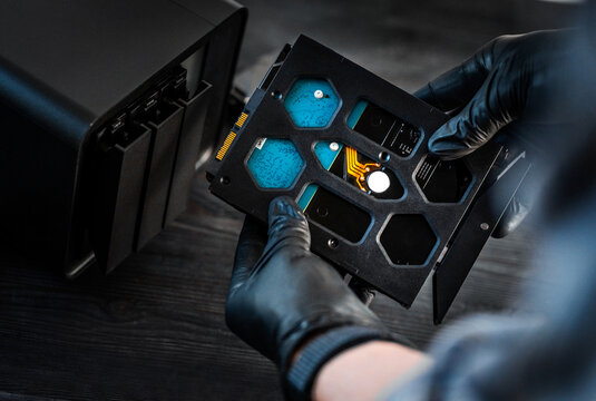 Technician Inserts A Hard Disk Drive Into A Nas Server Bay And Configures Local Server Storage
