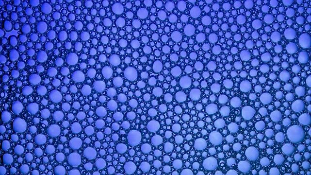 Purple foam bubbles creating abstract liquid texture background