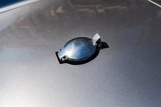 Silver fuel filler cap of a Porsche 550 Spyder.