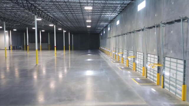 Large industrial facility with a long row of loading dock doors and polished concrete floor