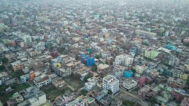 Aerial drone upward over dense colorful Patna India cityscape