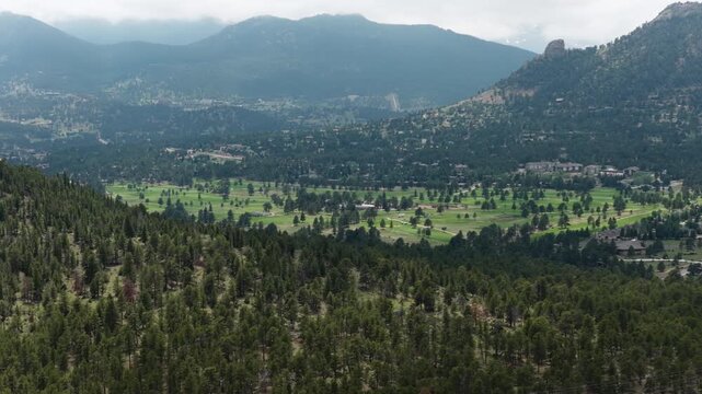 Aerial of golf course and lodging in Estes Park Colorado in summer time nestled in Rocky Mountains on cloudy day