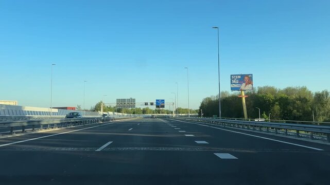 Amsterdam Netherlands highway, Sunlit urban highway with light traffic