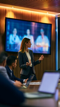 The senior healthcare administrator confidently explained the ROI driven by AI on a large screen, while the executive boardroom was softly lit, highlighting the polished corporate professionalism with