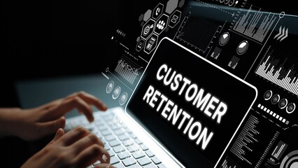 Hands on Laptop with Customer Retention Concept and Data Analytics Visualization in Dark...