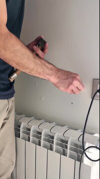 Man makes holes on the wall. High quality 4k footage