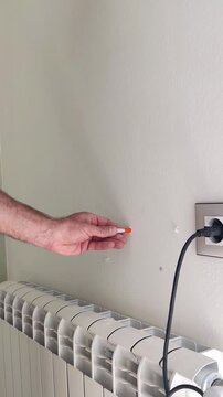 Man makes holes on the wall. High quality 4k footage