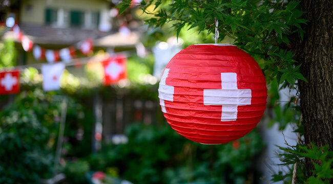 Garden event for Swiss National Day featuring red paper lanterns