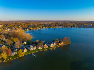Fototapeta premium Waterfront residential houses aerial view in the morning on Walled Lake in city of Novi, Michigan MI, USA. 
