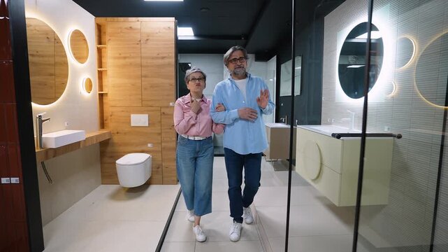 Senior couple choosing bathroom fixtures in a showroom