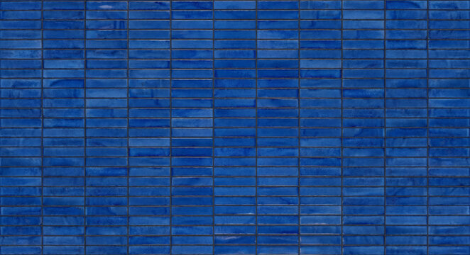 High angle view of modern dark blue mosaic rectangular ceramic tiles arranged in a neat geometric pattern for bathroom kitchen wall decoration.