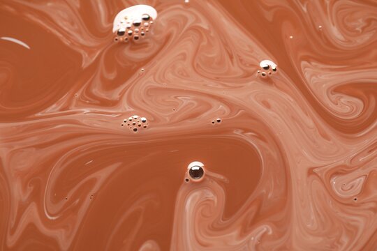 Delicious coffee with milk and bubbles as background, top view