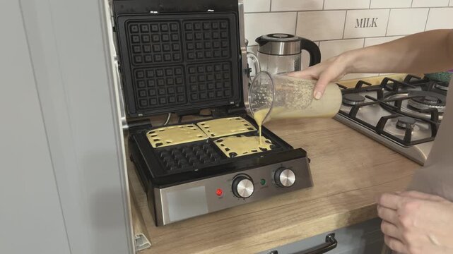 Evenly pouring batter into waffle iron cells for perfect shape Homemade baking preparation food video for tutorials and recipe content