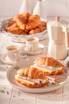 Hot and tasty french croissant with ham and cheese.